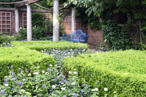 blue-bench-in-beautiful-english-garden Beautiful landscaping surrounds a private swimming pool